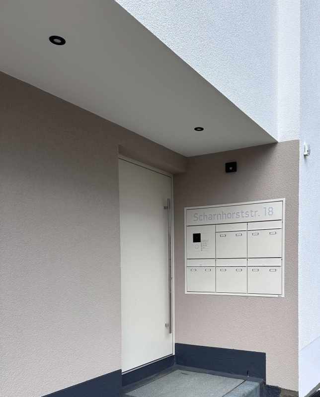 Stainless steel letterbox system GOETHE with illuminated lettering and GIRA System 106